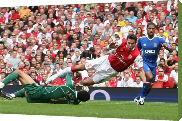 Robin van Persie (Arsenal) is fouled by David James (Portsmouth) for Arsenals penalty