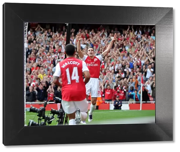 Robin van Persie celebrates scoring his and Arsenals 2nd goal, his 100th goal for Arsenal with Theo Walcott. Arsenal 3: 0 Bolton Wanderers. Barclays Premier League. Emirates Stadium, 24  /  9  /  11. Credit : Arsenal Football Club  / 
