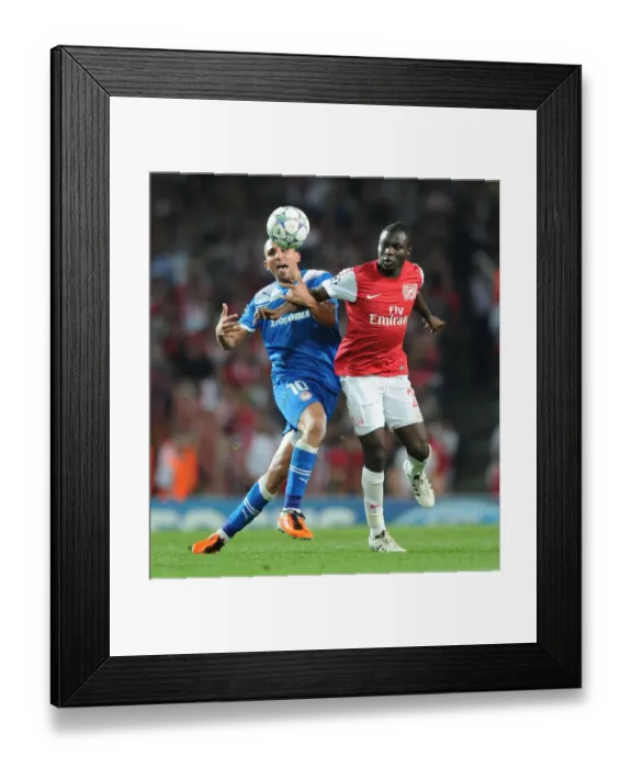 Framed Print : Arsenal's Frimpong Wins Ball from Olympiacos Djebbour in UCL Clash Framed Print : Arsenal's Frimpong Wins Ball from Olympiacos Djebbour in UCL Clash