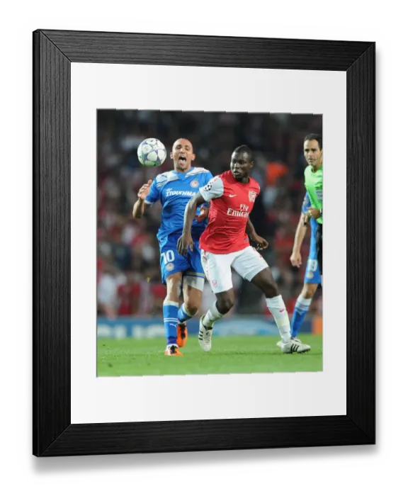 Framed Print : Frimpong Steals the Ball from Djebbour in Thrilling Arsenal-Olympiacos UCL Clash