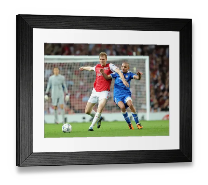 Framed Print : Arsenal Overcomes Olympiacos: Per Mertesacker's Goal Secures 2-1 Victory in UEFA Champions League Group F