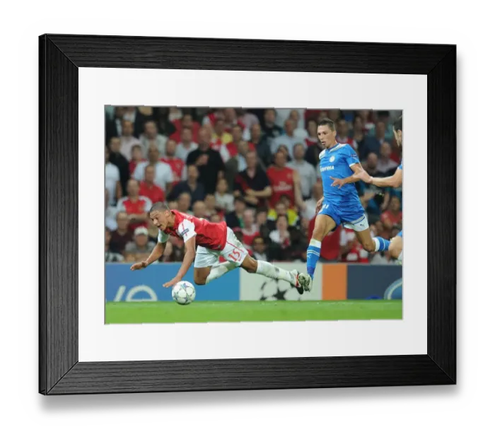 Framed Print : Arsenal's Oxlade-Chamberlain Fouls by Holebas in 2011-12 Champions League Clash Framed Print : Arsenal's Oxlade-Chamberlain Fouls by Holebas in 2011-12 Champions League Clash
