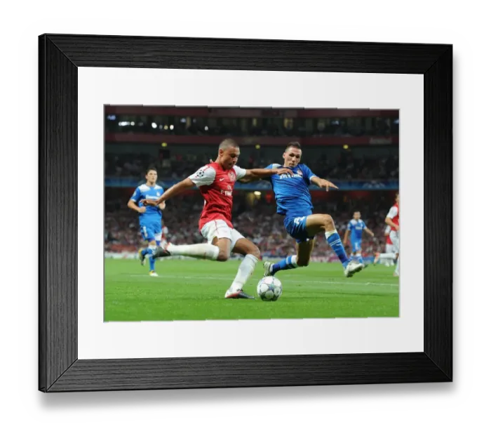 Framed Print : Arsenal's Alex Oxlade-Chamberlain Faces Off Against Olympiacos Joes Holebas in Champions League Clash Framed Print : Arsenal's Alex Oxlade-Chamberlain Faces Off Against Olympiacos Joes Holebas in Champions League Clash