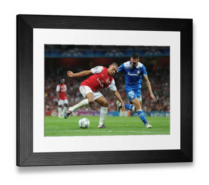 Framed Print : Clash of Champions: Oxlade-Chamberlain vs. Holebas in Arsenal's UEFA Battle