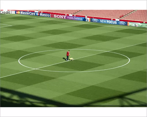 Arsenal Groundsman Paul Ashcroft makes out the pitch before the match. Arsenal 2: 1 Olympiacos