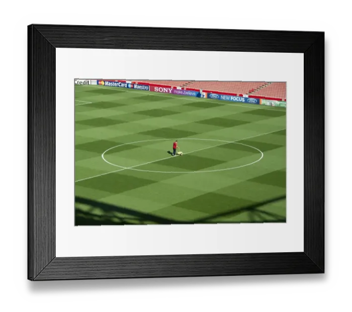 Framed Print : Arsenal Groundsman Paul Ashcroft makes out the pitch before the match. Arsenal 2: 1 Olympiacos