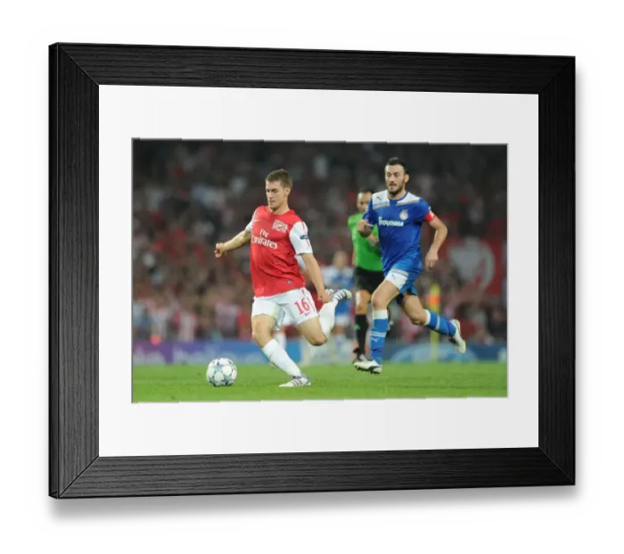 Framed Print : Arsenal's Aaron Ramsey Outmaneuvers Olympiacos Vassilis Torossidis during the 2011-12 Champions League Clash Framed Print : Arsenal's Aaron Ramsey Outmaneuvers Olympiacos Vassilis Torossidis during the 2011-12 Champions League Clash