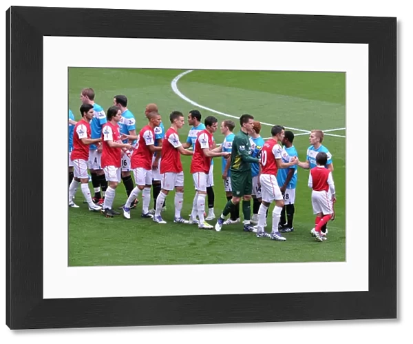 The Arsenal player shake hands with the Sunderland team before the match