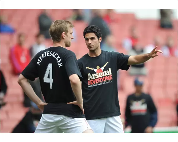 Mikel Arteta and Per Mertesacker (Arsenal) warm up in thier Arsenal for Everyone T Shirt