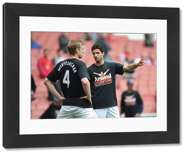 Mikel Arteta and Per Mertesacker (Arsenal) warm up in thier Arsenal for Everyone T Shirt