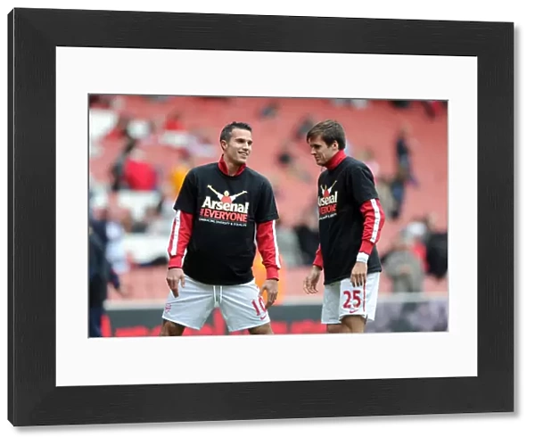 Robin van Persie and Carl Jenkinson (Arsenal) warm up in thier Arsenal for Everyone T Shirt