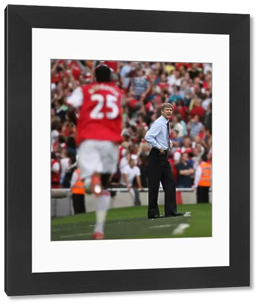 Arsene Wenger watches Emmanuel Adebayor celebrate scoring Arsenals 2nd goal his 1st