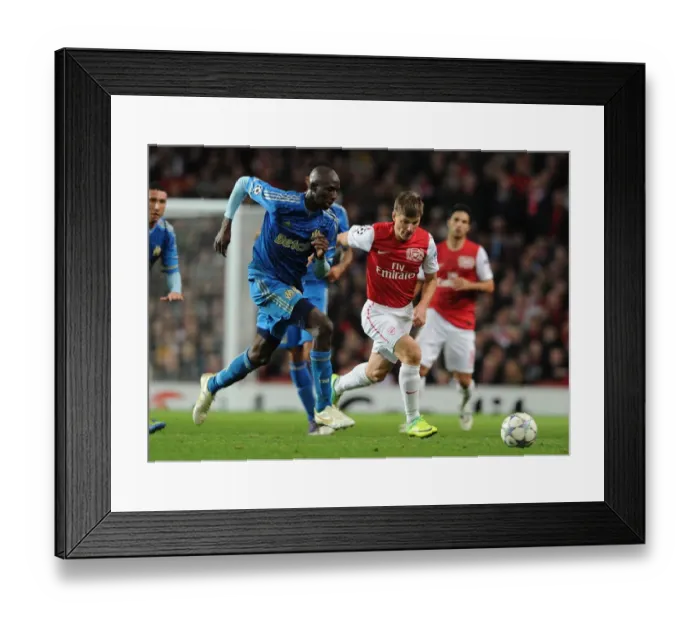 Framed Print : Arsenal's Andrey Arshavin Breaks Past Marseille's Alou Diarra in 2011-12 Champions League Clash Framed Print : Arsenal's Andrey Arshavin Breaks Past Marseille's Alou Diarra in 2011-12 Champions League Clash