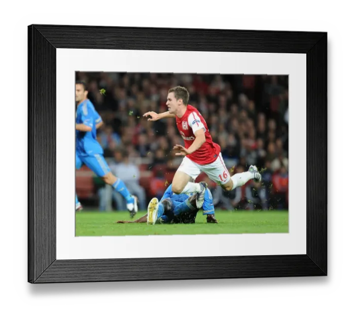 Framed Print : Aaran Ramsey (Arsenal) Alou Diarra (Marseille). Arsenal 0: 0 Marseille. UEFA Champions League