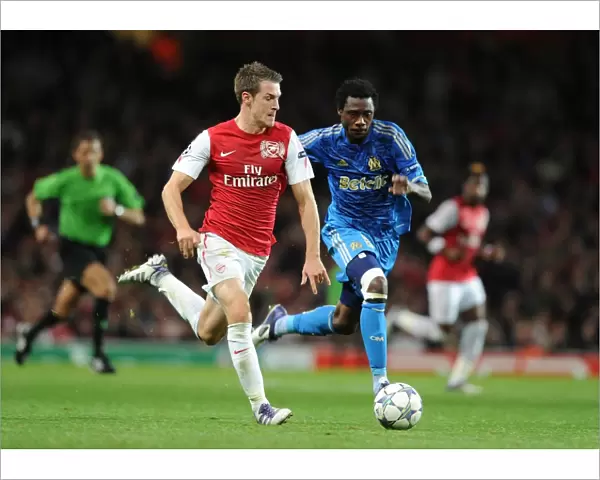 Arsenal's Aaron Ramsey Outmaneuvers Marseille's Koulouté in 2011-12 Champions League Clash