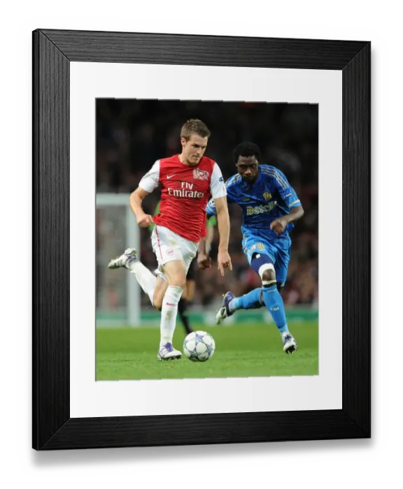Framed Print : Arsenal's Aaron Ramsey Outsmarts Marseille's Koulouté in 2011-12 Champions League Showdown Framed Print : Arsenal's Aaron Ramsey Outsmarts Marseille's Koulouté in 2011-12 Champions League Showdown