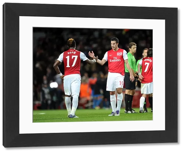 Robin van Persie shakes hands with Alex Song (Arsenal) at the end of the match
