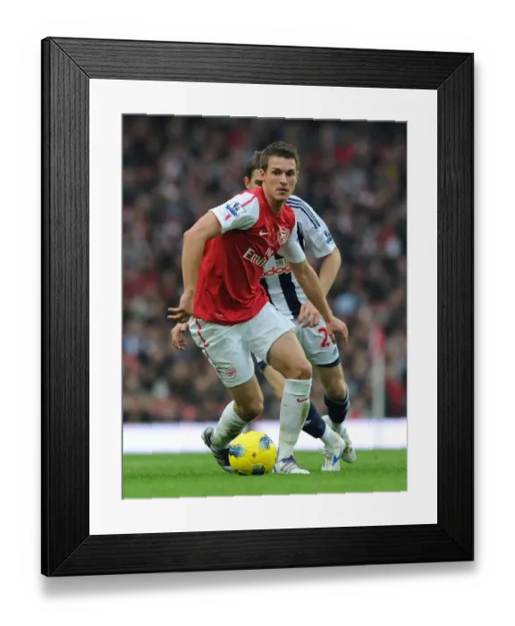 Framed Print : Arsenal's Aaron Ramsey Outmaneuvers West Brom's Zoltan Gera Framed Print : Arsenal's Aaron Ramsey Outmaneuvers West Brom's Zoltan Gera