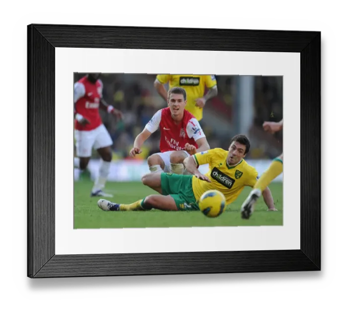 Framed Print : Aaron Ramsey Tackles Russell Martin: Intense Moment from Norwich City vs. Arsenal (2011-12) Framed Print : Aaron Ramsey Tackles Russell Martin: Intense Moment from Norwich City vs. Arsenal (2011-12)