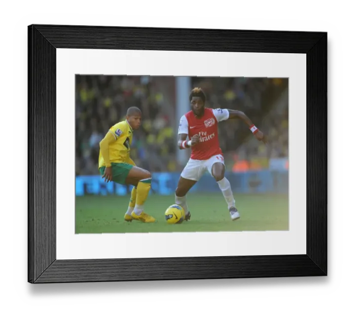 Framed Print : Arsenal's Alex Song Clashes with Norwich's Simeon Jackson in Premier League Showdown at Carrow Road, November 19, 2011