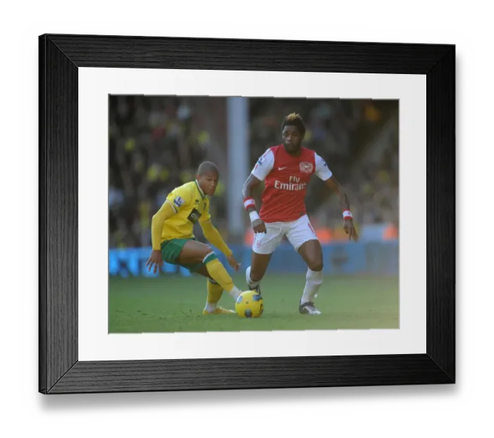Framed Print : Arsenal's Alex Song vs. Norwich's Simeon Jackson: Barclays Premier League Clash at Carrow Road (November 19, 2011)