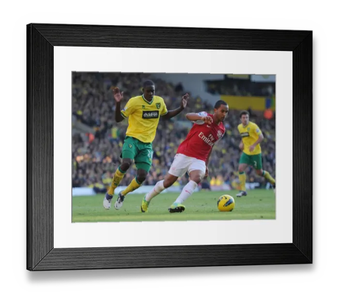 Framed Print : Theo Walcott vs. Leon Barnett: A Premier League Battle at Carrow Road, November 2011