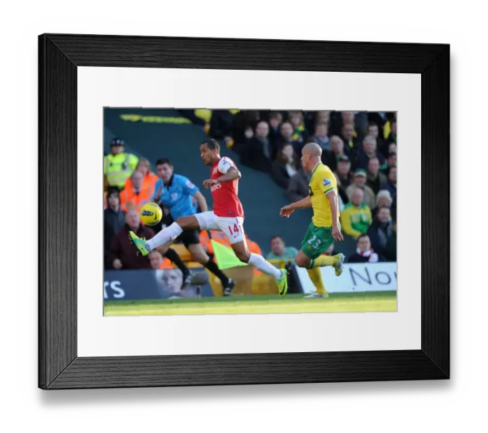 Framed Print : Theo Walcott vs Marc Tierney: A Premier League Battle at Carrow Road, November 2011
