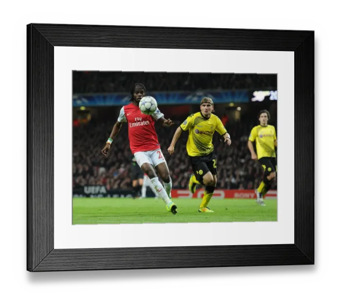Framed Print : Arsenal's Gervinho Outmaneuvers Dortmund's Schmelzer in Champs League Showdown (2011-12) Framed Print : Arsenal's Gervinho Outmaneuvers Dortmund's Schmelzer in Champs League Showdown (2011-12)