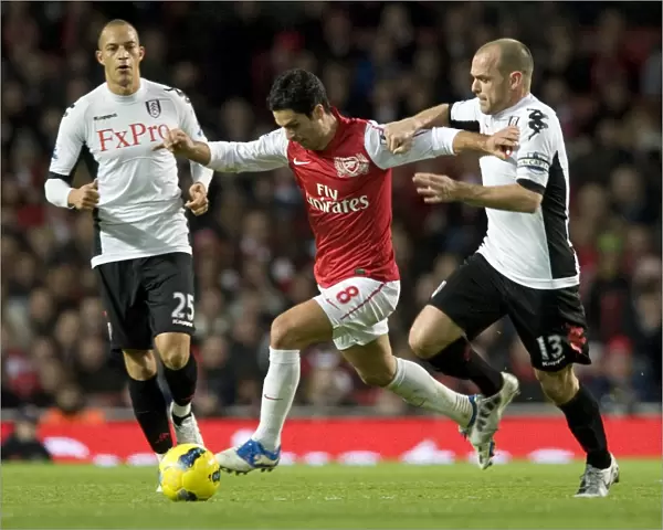 Mikel Arteta of Arsenal breaks past Danny Murphy of Fulham during the Barclays Premier League match between Arsenal and Fulham at Emirates Stadium on November 26, 2011 in London, England. Credit; Arsenal