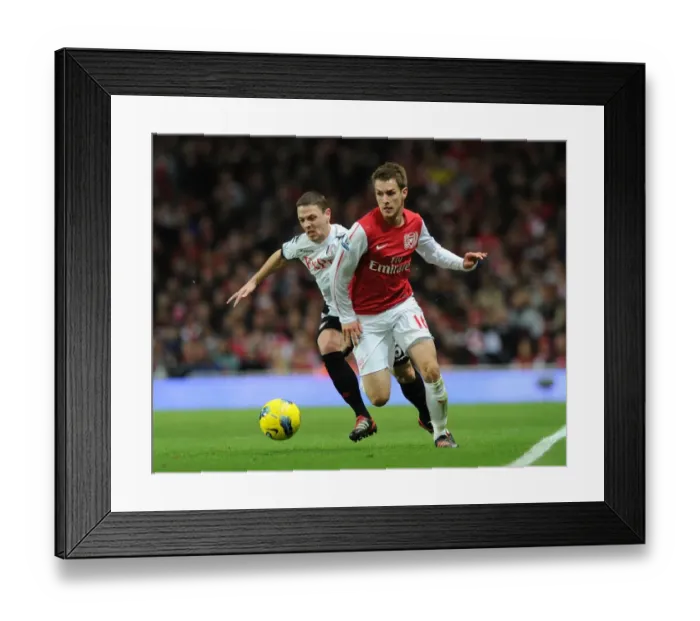 Framed Print : Arsenal's Aaron Ramsey Outmaneuvers Fulham's Chris Baird Framed Print : Arsenal's Aaron Ramsey Outmaneuvers Fulham's Chris Baird
