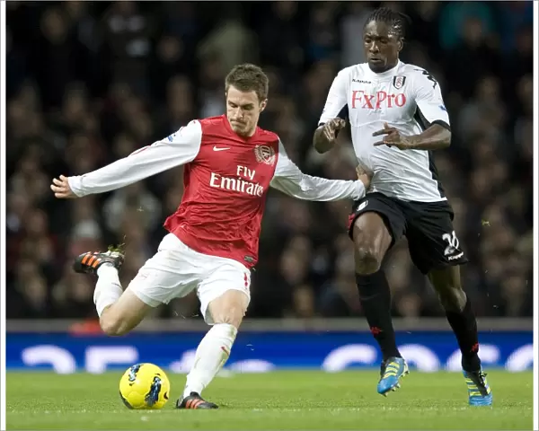 Aaron Ramsey of Arsenal takes on Dickson Etuhu of Fulham during the Barclays Premier League match between Arsenal and Fulham at Emirates Stadium on November 26, 2011 in London, England. Credit; Arsenal