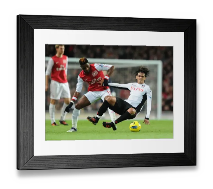 Framed Print : Arsenal's Alex Song Tackles Fulham's Bryan Ruiz in Premier League Clash