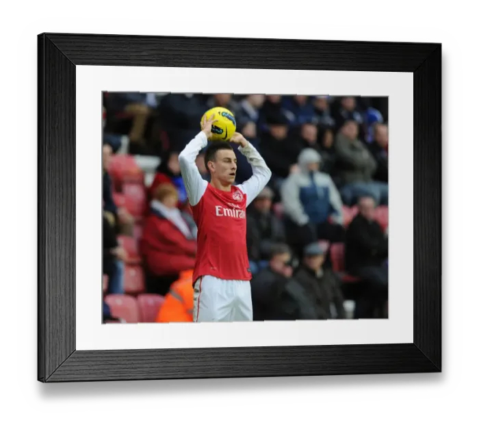 Framed Print : Laurent Koscielny Focuses in Wigan Athletic vs Arsenal Premier League Clash (2011-12)