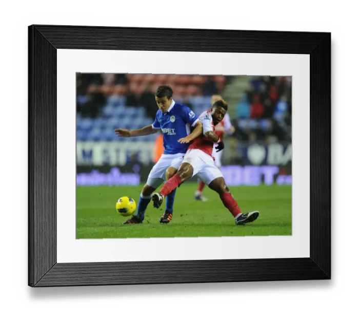 Framed Print : Arsenal's Alex Song Tackles Wigan's Franco Di Santo in Premier League Clash Framed Print : Arsenal's Alex Song Tackles Wigan's Franco Di Santo in Premier League Clash