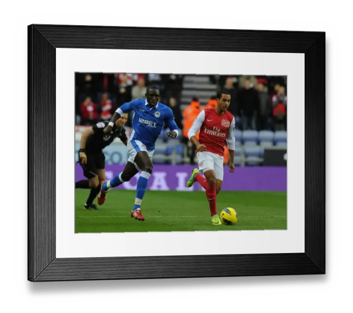 Framed Print : Theo Walcott Surges Past Mohamed Diame: Wigan Athletic vs. Arsenal, Premier League 2011-12 Framed Print : Theo Walcott Surges Past Mohamed Diame: Wigan Athletic vs. Arsenal, Premier League 2011-12