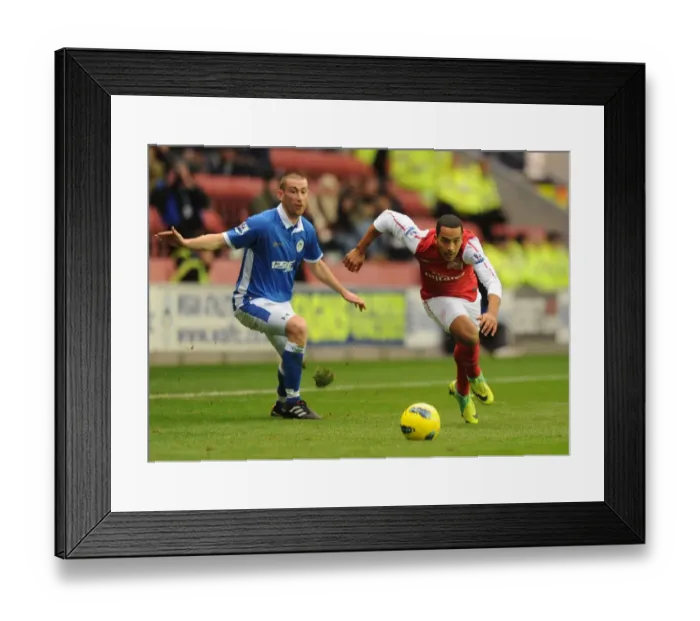 Framed Print : Theo Walcott Surges Past Wigan's David Jones in Premier League Clash (Wigan Athletic vs Arsenal, 2011-12) Framed Print : Theo Walcott Surges Past Wigan's David Jones in Premier League Clash (Wigan Athletic vs Arsenal, 2011-12)