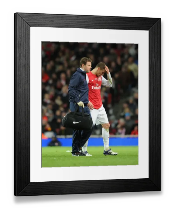 Framed Print : Arsenal's Thomas Vermaelen Carried Off Injured Against Everton (2011-12) Framed Print : Arsenal's Thomas Vermaelen Carried Off Injured Against Everton (2011-12)