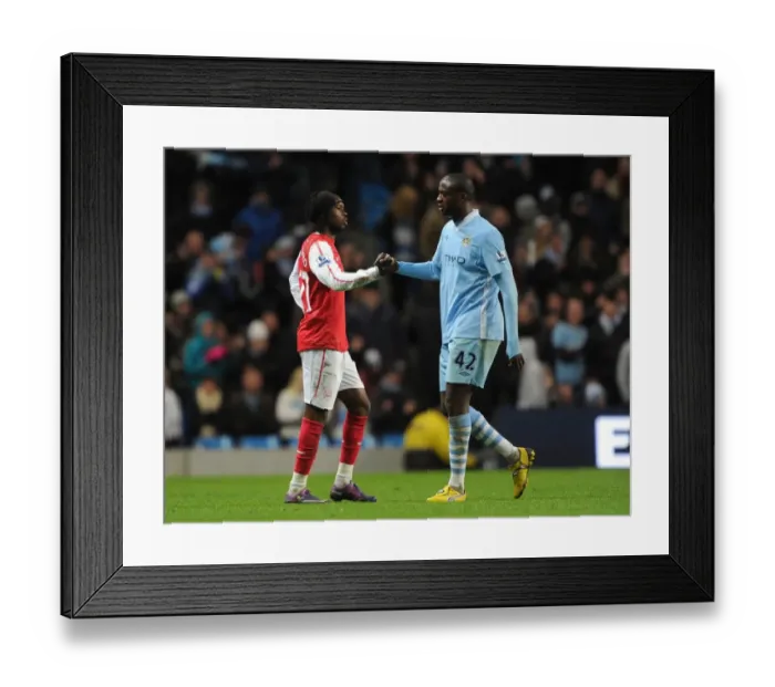 Framed Print : Gervinho and Yaya Toure: A Moment of Sportsmanship Amidst Manchester City vs. Arsenal Rivalry (2011-12)