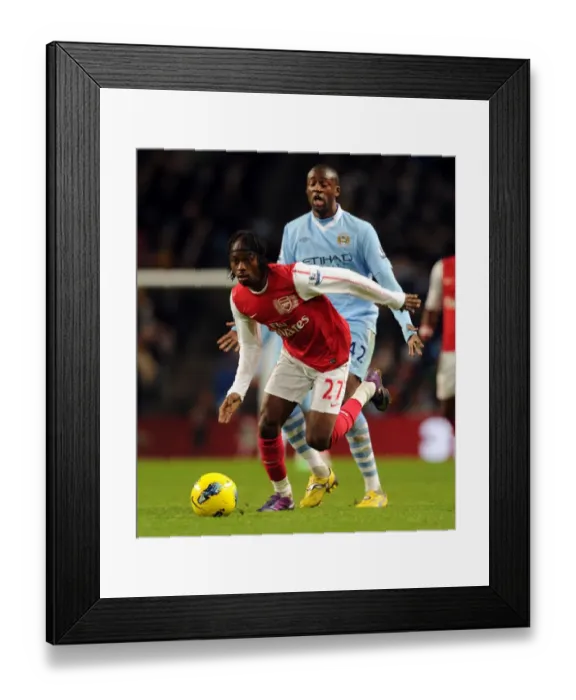Framed Print : Gervinho vs Yaya Toure: A Premier League Showdown at Etihad Stadium