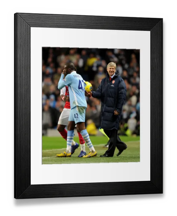 Framed Print : Arsene Wenger and Yaya Toure Share a Light-Hearted Moment Amidst Manchester City vs. Arsenal Rivalry (2011-12)