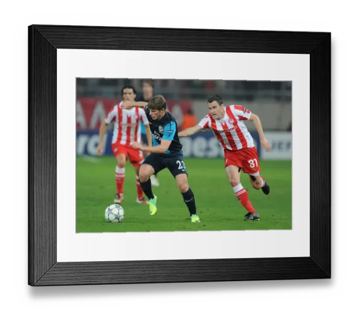 Framed Print : Arshavin vs. Orbaiz: A Champions League Showdown at Georgios Karaiskakis Stadium - Arsenal's Andrey Arshavin Outmaneuvers Pablo Orbaiz of Olympiacos (December 2011) Framed Print : Arshavin vs. Orbaiz: A Champions League Showdown at Georgios Karaiskakis Stadium - Arsenal's Andrey Arshavin Outmaneuvers Pablo Orbaiz of Olympiacos (December 2011)