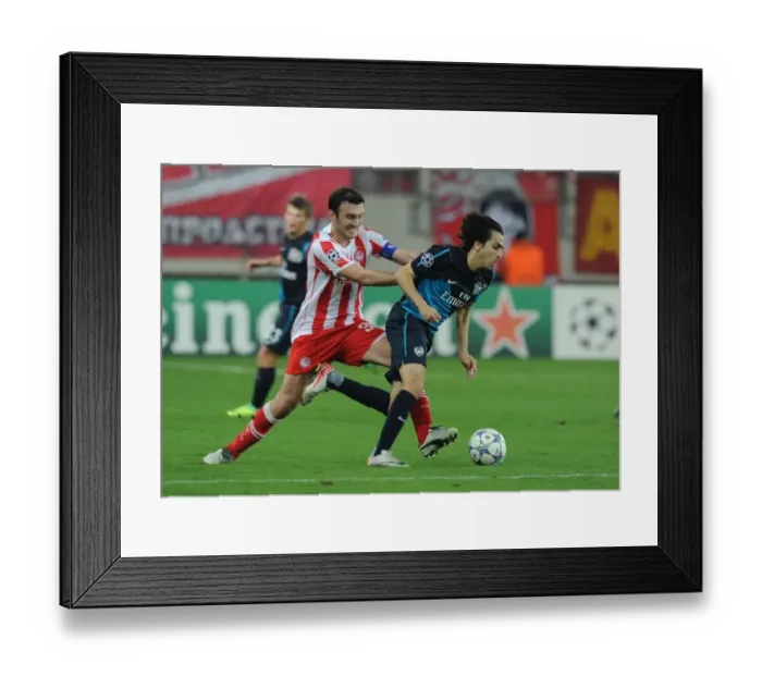 Framed Print : Yossi Benayoun vs. Vassilis Torosidis: A Battle in the UEFA Champions League between Olympiacos and Arsenal Framed Print : Yossi Benayoun vs. Vassilis Torosidis: A Battle in the UEFA Champions League between Olympiacos and Arsenal