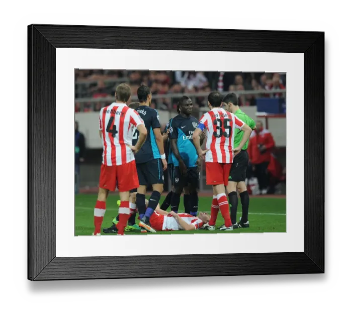 Framed Print : Emmanuel Frimpong Booked in Olympiacos vs. Arsenal UEFA Champions League Clash (December 2011)