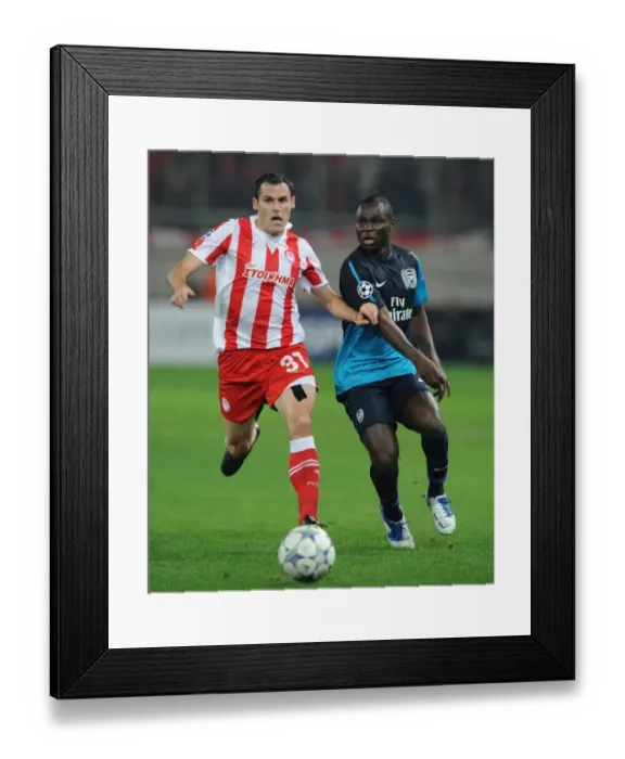 Framed Print : Clash of Midfielders: Frimpong vs. Orbaiz - Olympiacos vs. Arsenal, UEFA Champions League, 2011