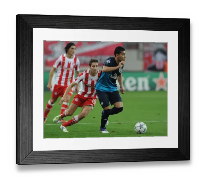 Framed Print : Andre Santos vs. David Fuster: A Battle in the UEFA Champions League between Olympiacos and Arsenal Framed Print : Andre Santos vs. David Fuster: A Battle in the UEFA Champions League between Olympiacos and Arsenal