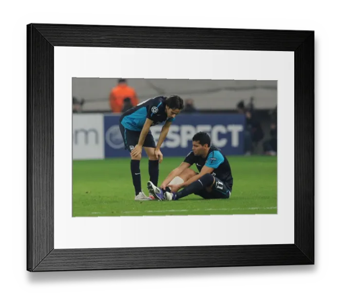 Framed Print : Andre Santos Holds Injured Ankle as Yossi Benayoun Looks On: Olympiacos vs. Arsenal, UEFA Champions League, 2011 Framed Print : Andre Santos Holds Injured Ankle as Yossi Benayoun Looks On: Olympiacos vs. Arsenal, UEFA Champions League, 2011