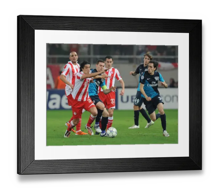 Framed Print : Thomas Vermaelen vs. Yossi Benayoun and Franck Modest: Intense Clash Between Olympiacos and Arsenal FC in the UEFA Champions League Framed Print : Thomas Vermaelen vs. Yossi Benayoun and Franck Modest: Intense Clash Between Olympiacos and Arsenal FC in the UEFA Champions League