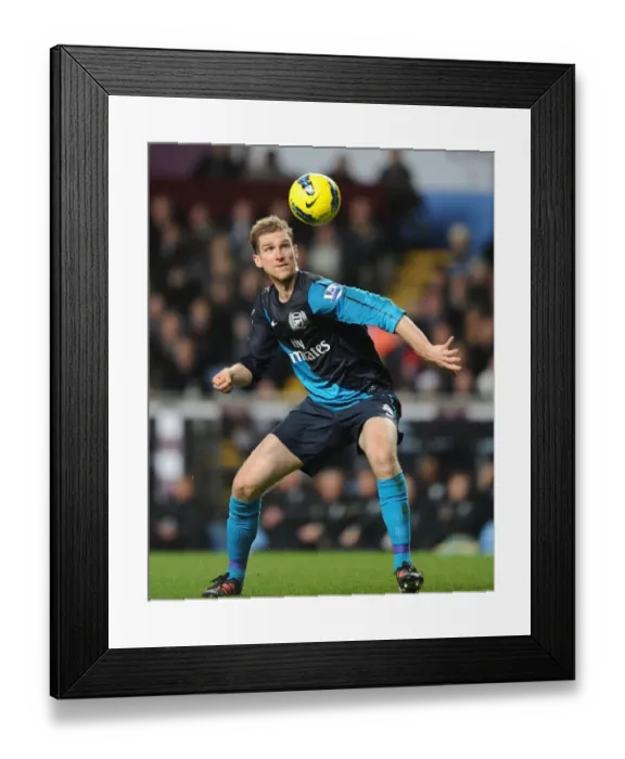 Framed Print : Per Mertesacker's Intense Concentration: Aston Villa vs Arsenal (2011-12) Framed Print : Per Mertesacker's Intense Concentration: Aston Villa vs Arsenal (2011-12)