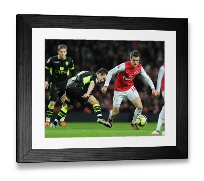 Framed Print : Arsenal's Aaron Ramsey Scores Past Leeds Danny Pugh in FA Cup Third Round Clash Framed Print : Arsenal's Aaron Ramsey Scores Past Leeds Danny Pugh in FA Cup Third Round Clash