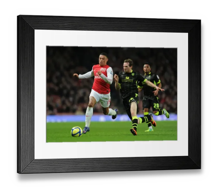Framed Print : Arsenal's Oxlade-Chamberlain Outsmarts Leeds White in FA Cup Showdown Framed Print : Arsenal's Oxlade-Chamberlain Outsmarts Leeds White in FA Cup Showdown